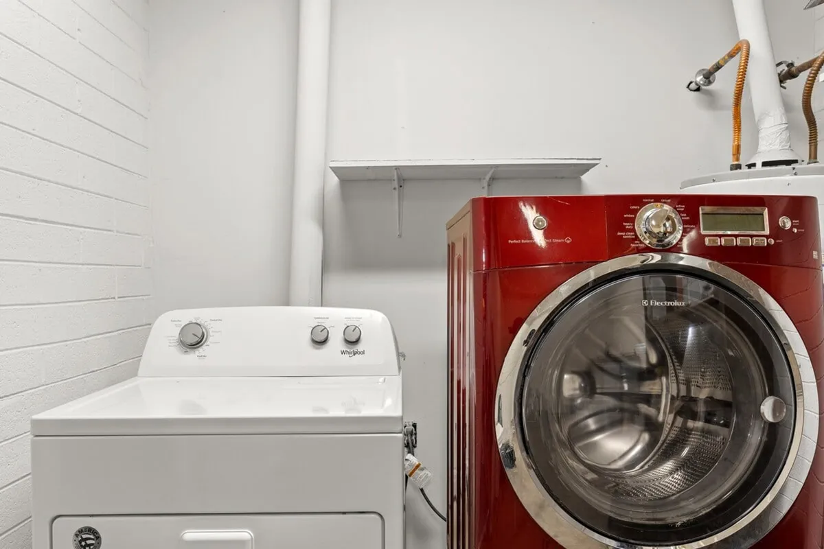 A practical laundry area with a washer and dryer, neatly arranged for easy use. The space suggests convenience for daily routines and the ability to handle longer stays with ease.
